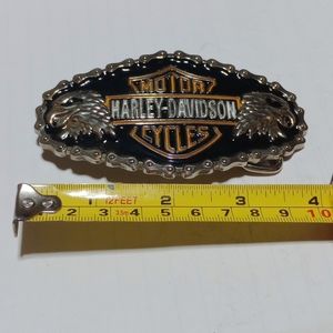 Harley Davidson belt buckle with 2 silver eagle heads .